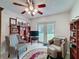 Cozy seating area featuring ceiling fan, tile flooring, and access to the backyard at 7700 Fairlawn Dr, Hudson, FL 34667