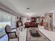 Bright living area with tile floors, a comfortable sofa, and a view of adjacent rooms at 7700 Fairlawn Dr, Hudson, FL 34667