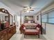 Spacious main bedroom featuring tile floors and a four poster bed at 7700 Fairlawn Dr, Hudson, FL 34667