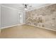 Bedroom featuring a decorative wall, tile flooring, neutral walls, and an interior door at 8240 Gulf Way, Hudson, FL 34667