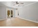 Bedroom featuring tile flooring, neutral walls, a ceiling fan, and sliding glass doors at 8240 Gulf Way, Hudson, FL 34667