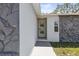 Close up of front entrance with charming decorative door and rock facade at 8240 Gulf Way, Hudson, FL 34667
