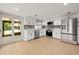 Modern kitchen features stainless steel appliances and white cabinetry at 8240 Gulf Way, Hudson, FL 34667