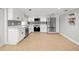 Updated kitchen boasts stainless steel appliances, white cabinets, and tile flooring at 8240 Gulf Way, Hudson, FL 34667