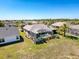 Aerial view of the backyard featuring a screened pool, lush landscaping, and a serene outdoor setting at 8523 Regal Ln, Hudson, FL 34667