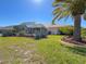 Lush backyard showcasing a screened pool enclosure, mature trees, and beautifully landscaped gardens at 8523 Regal Ln, Hudson, FL 34667