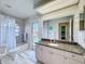 Bathroom with granite countertop vanity, tile flooring, and a combined bathtub and shower next to a window at 8523 Regal Ln, Hudson, FL 34667