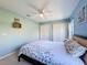 Bedroom with a queen bed, light-toned carpet, a ceiling fan, and a closet; two-tone walls give a cheery feel at 8523 Regal Ln, Hudson, FL 34667