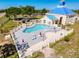 Inviting community pool area with lounge chairs, tables, and umbrellas, perfect for outdoor relaxation at 8523 Regal Ln, Hudson, FL 34667