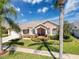 Charming home with a well-manicured lawn, beautiful landscaping, and a welcoming entryway at 8523 Regal Ln, Hudson, FL 34667