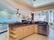Bright kitchen with stainless steel appliances, granite countertops, and tile flooring provides ample cooking space at 8523 Regal Ln, Hudson, FL 34667