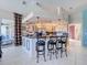 Bright kitchen features a large kitchen island with seating and views to the backyard at 8523 Regal Ln, Hudson, FL 34667