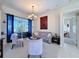 Comfortable living room featuring neutral tones, a decorative chandelier, and sliding glass doors with backyard views at 8523 Regal Ln, Hudson, FL 34667