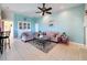Well lit living room boasts a plush sofa, tile floors, ceiling fan, and a neutral color palette at 8523 Regal Ln, Hudson, FL 34667