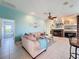 Inviting living room features plush sofa, fireplace, tile flooring, and a neutral color palette at 8523 Regal Ln, Hudson, FL 34667