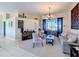 Cozy living room featuring plush seating, soft carpeting, and stylish décor under a decorative chandelier at 8523 Regal Ln, Hudson, FL 34667