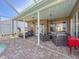 Inviting covered patio with lounge chairs, ceiling fans, and comfortable seating area at 8523 Regal Ln, Hudson, FL 34667