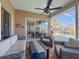 Relaxing covered patio featuring stylish furniture, ceiling fan, and views of the screened pool area at 8523 Regal Ln, Hudson, FL 34667