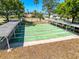Outdoor shuffleboard courts under shaded canopies, perfect for leisurely recreation at 8523 Regal Ln, Hudson, FL 34667