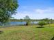 Lush backyard with mature trees and serene lake view, perfect for relaxation at 9159 Trevino Dr, Weeki Wachee, FL 34613