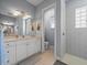 Modern bathroom with a double vanity, tile shower, and contemporary fixtures at 9159 Trevino Dr, Weeki Wachee, FL 34613