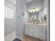Modern bathroom with glass block window, vanity, and tiled walk-in shower at 9159 Trevino Dr, Weeki Wachee, FL 34613