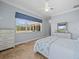 Bright bedroom showcasing outdoor views, neutral walls, and white dressers at 9159 Trevino Dr, Weeki Wachee, FL 34613