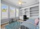 Cozy bedroom offers a built-in desk, shelving, and ample natural light at 9159 Trevino Dr, Weeki Wachee, FL 34613