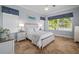 Serene bedroom featuring a queen-sized bed, natural light, and stylish accents at 9159 Trevino Dr, Weeki Wachee, FL 34613