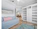 Bright bedroom features built-in bookshelves, a daybed, and beach-themed decor at 9159 Trevino Dr, Weeki Wachee, FL 34613