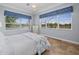 Light-filled bedroom with a queen bed, scenic views, and tasteful decor at 9159 Trevino Dr, Weeki Wachee, FL 34613
