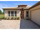 Attractive home featuring a brick driveway, manicured landscaping, and an attached garage at 9159 Trevino Dr, Weeki Wachee, FL 34613