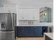 A kitchen showcases stainless steel appliances, modern cabinets, a wine rack, and stylish countertops at 9159 Trevino Dr, Weeki Wachee, FL 34613