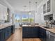 A kitchen showcases lake views from the breakfast nook, stainless steel appliances, and a center island with seating at 9159 Trevino Dr, Weeki Wachee, FL 34613