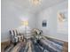 Bright living room with stylish striped chairs, glass table, and beautiful decorative rug at 9159 Trevino Dr, Weeki Wachee, FL 34613