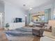 Spacious living area with sectional sofa, entertainment center, and scenic backyard views at 9159 Trevino Dr, Weeki Wachee, FL 34613