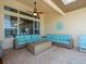 Comfortable covered patio with stylish seating, ceiling fan, and decorative accents for outdoor relaxation at 9159 Trevino Dr, Weeki Wachee, FL 34613