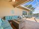 Outdoor patio with comfortable seating, a gas fire pit, and a view of the lake at 9159 Trevino Dr, Weeki Wachee, FL 34613