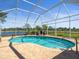 Stunning screened-in pool with scenic lake views at 9159 Trevino Dr, Weeki Wachee, FL 34613