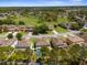 Aerial view of neighborhood homes with green lawns and mature trees in a residential community at 951 Nodding Shade Dr, Brooksville, FL 34604