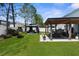 Large backyard featuring a covered patio, gazebo, and well-manicured lawn at 951 Nodding Shade Dr, Brooksville, FL 34604