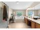 Bright bathroom with double vanity, soaking tub under a window, and a separate shower at 951 Nodding Shade Dr, Brooksville, FL 34604