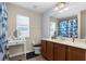 Bathroom featuring a vanity, mirror, and window, creating a functional and bright space for personal care at 951 Nodding Shade Dr, Brooksville, FL 34604