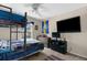 Bedroom featuring a bunk bed, TV, and a Chargers-themed decor, creating a fun and vibrant space at 951 Nodding Shade Dr, Brooksville, FL 34604