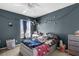 Bedroom with a stylish gray wall and a cozy bed, creating a relaxing and inviting space for rest and rejuvenation at 951 Nodding Shade Dr, Brooksville, FL 34604
