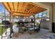 A covered patio with wicker seating and a grill overlooks the backyard at 951 Nodding Shade Dr, Brooksville, FL 34604