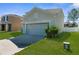 This house features a two-car garage, an expansive driveway, and an ample lawn at 951 Nodding Shade Dr, Brooksville, FL 34604