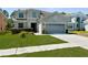 Charming two-story home featuring a well-maintained lawn and a two-car garage at 951 Nodding Shade Dr, Brooksville, FL 34604