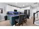 Stylish kitchen island with barstool seating, sink, and stainless steel appliances, with decorative blue lights at 951 Nodding Shade Dr, Brooksville, FL 34604