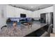 Kitchen island with marble countertop, stainless steel sink, stainless steel appliances, white cabinets at 951 Nodding Shade Dr, Brooksville, FL 34604
